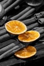 Bright orange circle on black toned cinnamon sticks background Royalty Free Stock Photo