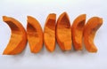 Bright orange colored pieces of fleshy pumpkin shell.