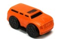 A bright orange colored toy van MPV multi purpose vehicle car against a white backdrop