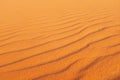 Bright orange desert sand rippled patterns for warm background and summer background