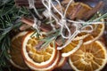 Bright orange dried round orange slices on a wooden board with cinnamon sticks, fir branches, ingredients for cooking or Christmas Royalty Free Stock Photo