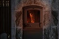 Bright orange flame, firewood burns in stove, fireplace in dark room, burning stone and enjoying warmth, cozy winter evening at