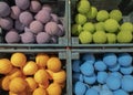 Bright orange, green, blue and purple effervescent balls for the bathroom in a wooden box in the market, top view Royalty Free Stock Photo