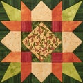 Bright orange-green geometric patchwork block from pieces of fab