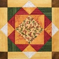 Bright orange-green geometric patchwork block from pieces of fabrics, detail of quilt