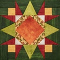 Bright orange-green geometric patchwork block from pieces of fabrics, detail of quilt