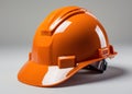 Bright orange hard hat placed against a clean white backdrop, construction site photo Royalty Free Stock Photo