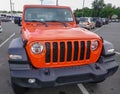 A bright orange Jeep Gladiator Sport seen on a dealership lot on this date