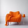 Bright Orange Knitted Chair In Monochromatic Still Life