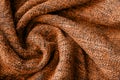 Bright orange knitted fabric texture. Crumpled twisted blanket background