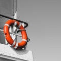 Bright orange lifebuoy on a yacht side