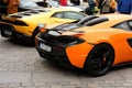 Bright orange McLaren sports race car in street