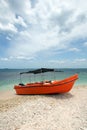 Bright orange panga / fishing boat on coral beach in Sri Lanka Royalty Free Stock Photo