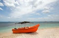 Bright orange panga / fishing boat on coral beach in Sri Lanka Royalty Free Stock Photo