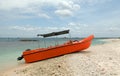 Bright orange panga / fishing boat on coral beach in Sri Lanka Royalty Free Stock Photo