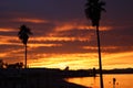 Bright orange and red Sunset over Lake Havasu Arizona with palm trees