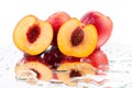 Peaches whole and cutted into two halves in water drops on white background isolated close up