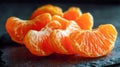 Juicy orange segments arranged in a row on a dark textured surface showcasing fresh, vibrant citrus fruit perfect for healthy Royalty Free Stock Photo