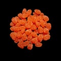 Bright orange sugar coated jelly candy sweet treats in a round pile heap on black kitchen surface Royalty Free Stock Photo