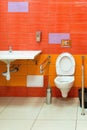 Bright orange toilet for people with disabilities