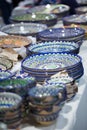 Bright oriental colored plates. Authentic dishes hand-painted in national style. Beautiful bowls and plates in the oriental bazaar Royalty Free Stock Photo