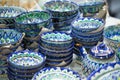 Bright oriental colored plates. Authentic dishes hand-painted in national style. Beautiful bowls and plates in the oriental bazaar Royalty Free Stock Photo
