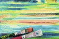 Bright painted canvas of artist and dirty artistic brushes, texture of mixed artistic oil paints, different colors, mix spots,