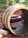 Bright painted corrugated pipe and tires on playground