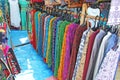 Bright Pants hang on hangers in a row. Showcase with clothes. Clothes India. Bazaar market in India, Anjuna market