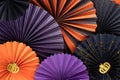 Bright paper fans in purple, orange and black colors of Halloween multi-layered composition.