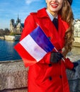 Woman in Paris with French flag looking into the distanc Royalty Free Stock Photo
