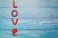 Bright pattern Love lettering with plasticine clay onblue wooden background. Love concept, saint valentines day Royalty Free Stock Photo