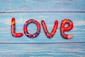 Bright pattern Love lettering with plasticine clay onblue wooden background. Love concept, saint valentines day Royalty Free Stock Photo