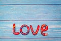 Bright pattern Love lettering with plasticine clay onblue wooden background. Love concept, saint valentines day Royalty Free Stock Photo