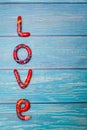 Bright pattern Love lettering with plasticine clay onblue wooden background. Love concept, saint valentines day Royalty Free Stock Photo