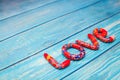 Bright pattern Love lettering with plasticine clay onblue wooden background. Love concept, saint valentines day Royalty Free Stock Photo