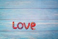 Bright pattern Love lettering with plasticine clay onblue wooden background. Love concept, saint valentines day Royalty Free Stock Photo