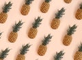 Bright pattern of many pineapples on a trendy soft beige pink background