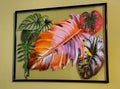 Bright photos of tropical plants and shiny leaves inside of a floating glass frame