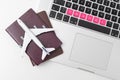 Passport , white plane model and computer laptop on white background . travel , visa and vacation concept