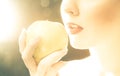 Bright picture of woman's lips with an apple