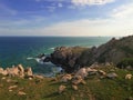 A bright picturesque sunset over the rocks of the sea shore