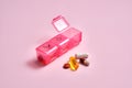 Bright pill box with different pills and vitamins.