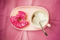 Bright pink bitten donut in plate and coffee, top view. Food concept Royalty Free Stock Photo