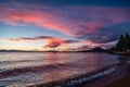 Pink and blue sunset with gentle waves in lower right corner from Lakeside Beach at Lake Tahoe