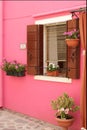 A bright pink building with a window