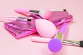 Bright pink decorative cosmetics tools and accessories for professional make up and visage on light background. Royalty Free Stock Photo