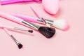 Bright pink decorative cosmetics tools and accessories for professional make up and visage on light background. Royalty Free Stock Photo