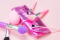 Bright pink decorative cosmetics tools and accessories for professional make up and visage on light background. Royalty Free Stock Photo