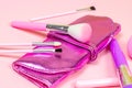 Bright pink decorative cosmetics tools and accessories for professional make up and visage on light background. Royalty Free Stock Photo